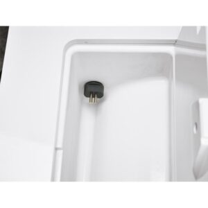 B CLASSIC - 17 LITRES plug inside a white storage compartment, close-up view.