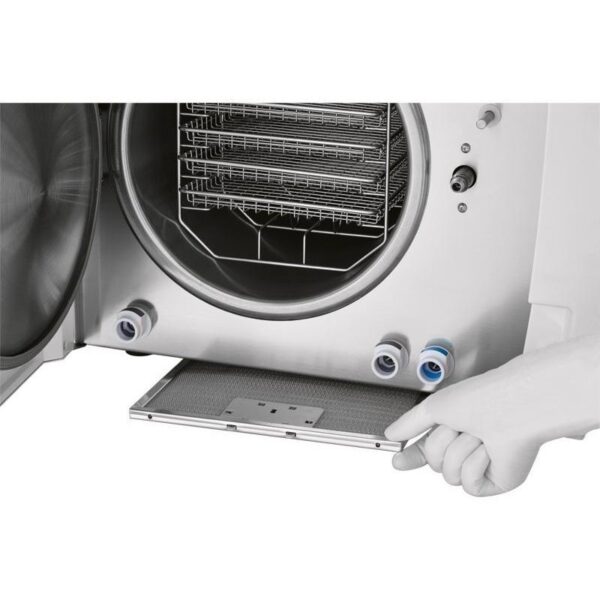 Hand pulling out the drip tray of a B CLASSIC - 28 LITRES laboratory autoclave.