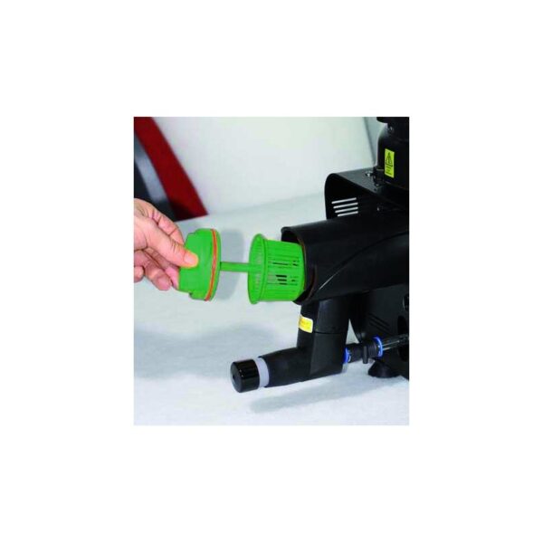 Hand removing a DG300 green cylindrical filter from a black device on a white surface.