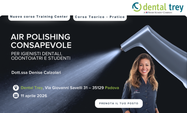 Igienista dentale in piedi sorridente accanto a un apparecchio per la lucidatura ad aria; sono mostrati i dettagli dell'evento.
