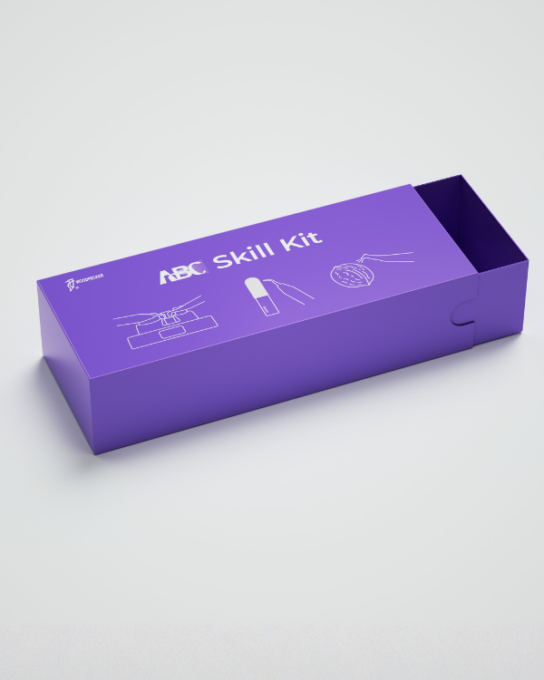 Una scatola viola EASY FILL etichettata ABC Skill Kit con illustrazioni a linee bianche.